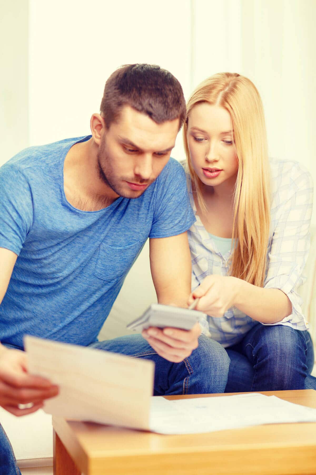 couple with papers and calculator at home